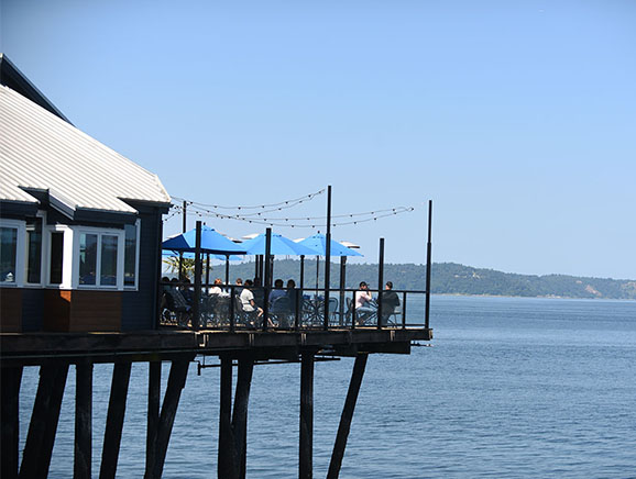 Outdoor deck seating at Duke's Seafood Ruston Way overlooking Puget Sound