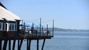 Outdoor deck seating at Duke's Seafood Ruston Way overlooking Puget Sound