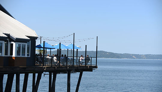 Outdoor deck seating at Duke's Seafood Ruston Way overlooking Puget Sound