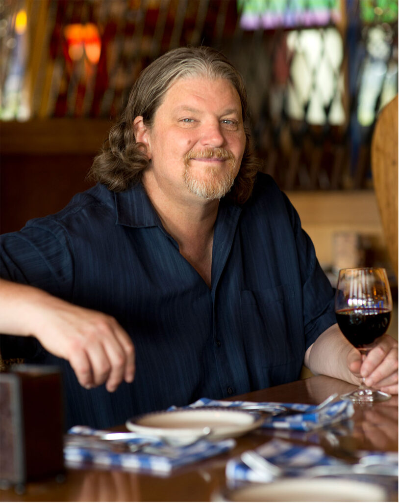 Bill Ranniger at Duke's Seafood with Red Wine Bill Ranniger at Duke's Seafood sitting with a glass of red wine