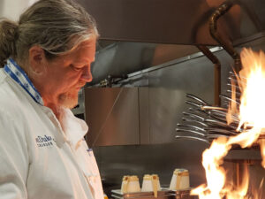 Bill Ranniger working with flames in the kitchen at Duke's Seafood