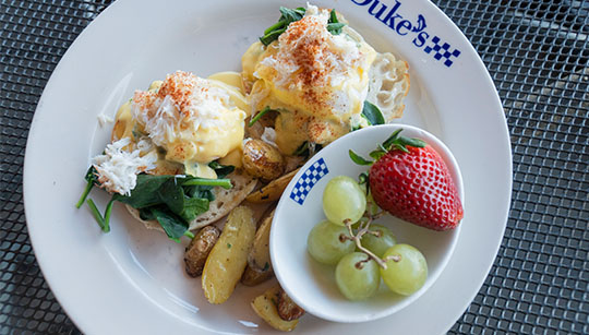 Duke's Seafood Eggs Bene "Duke" with fresh fruit breakfast entree
